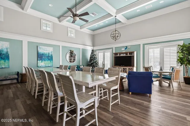 a living room with furniture a ceiling fan and a window