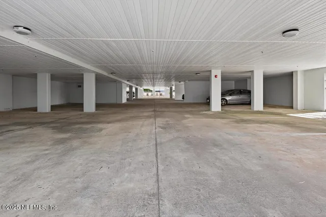 a living room with furniture and a large window with wooden floor