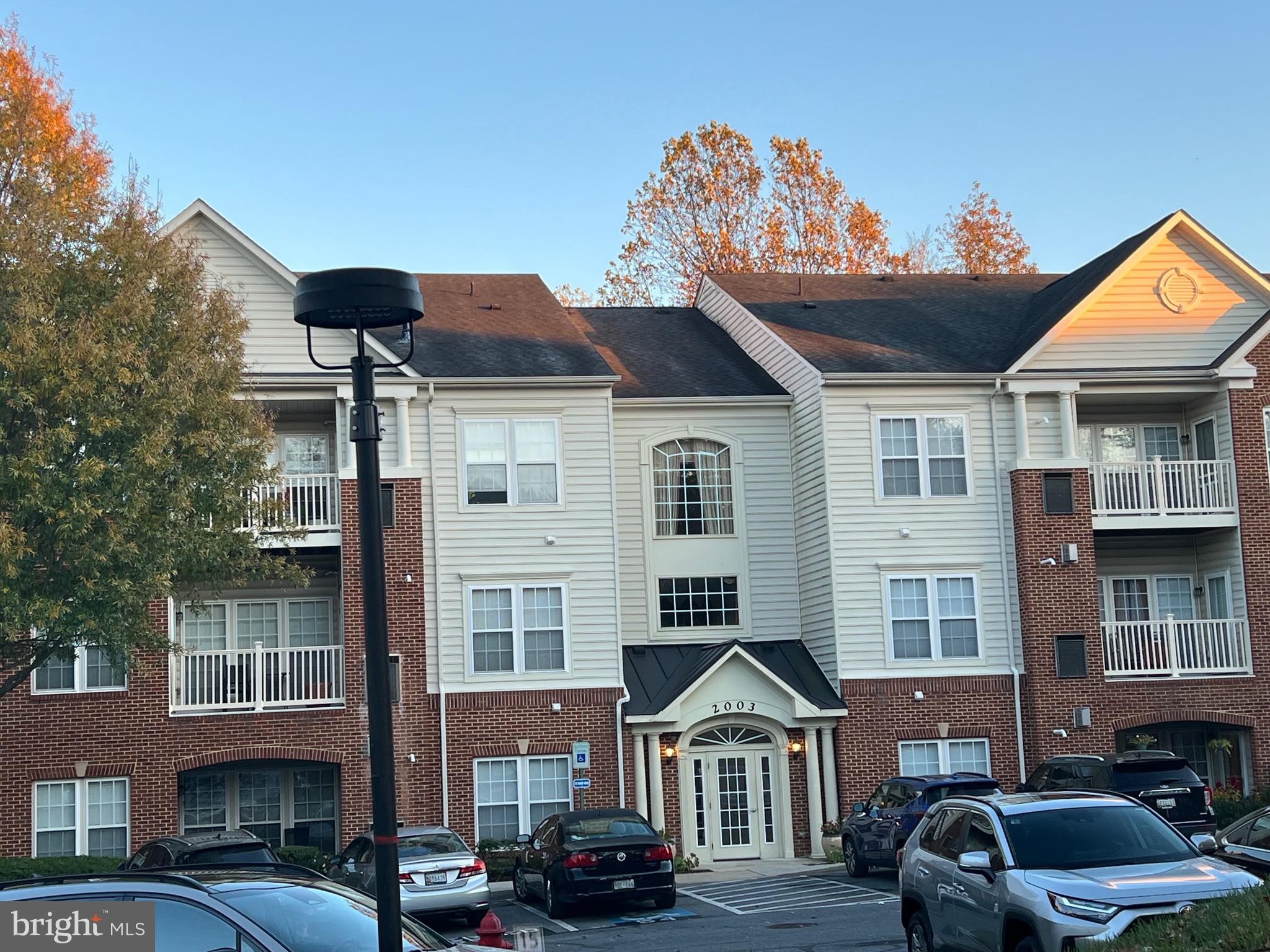 a front view of a residential apartment building with a yard