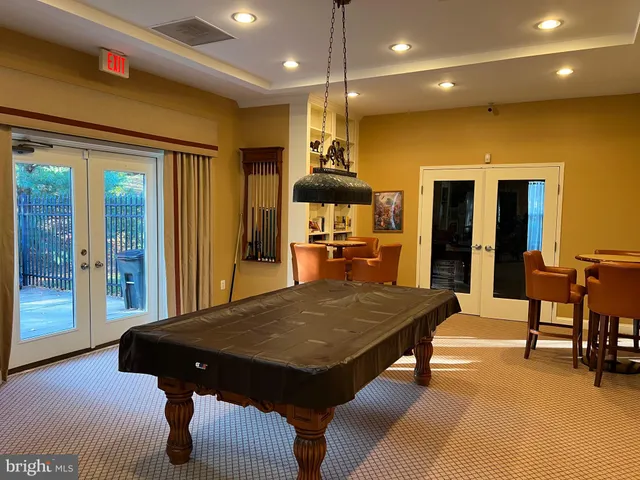 a living room with furniture rug and a mirror