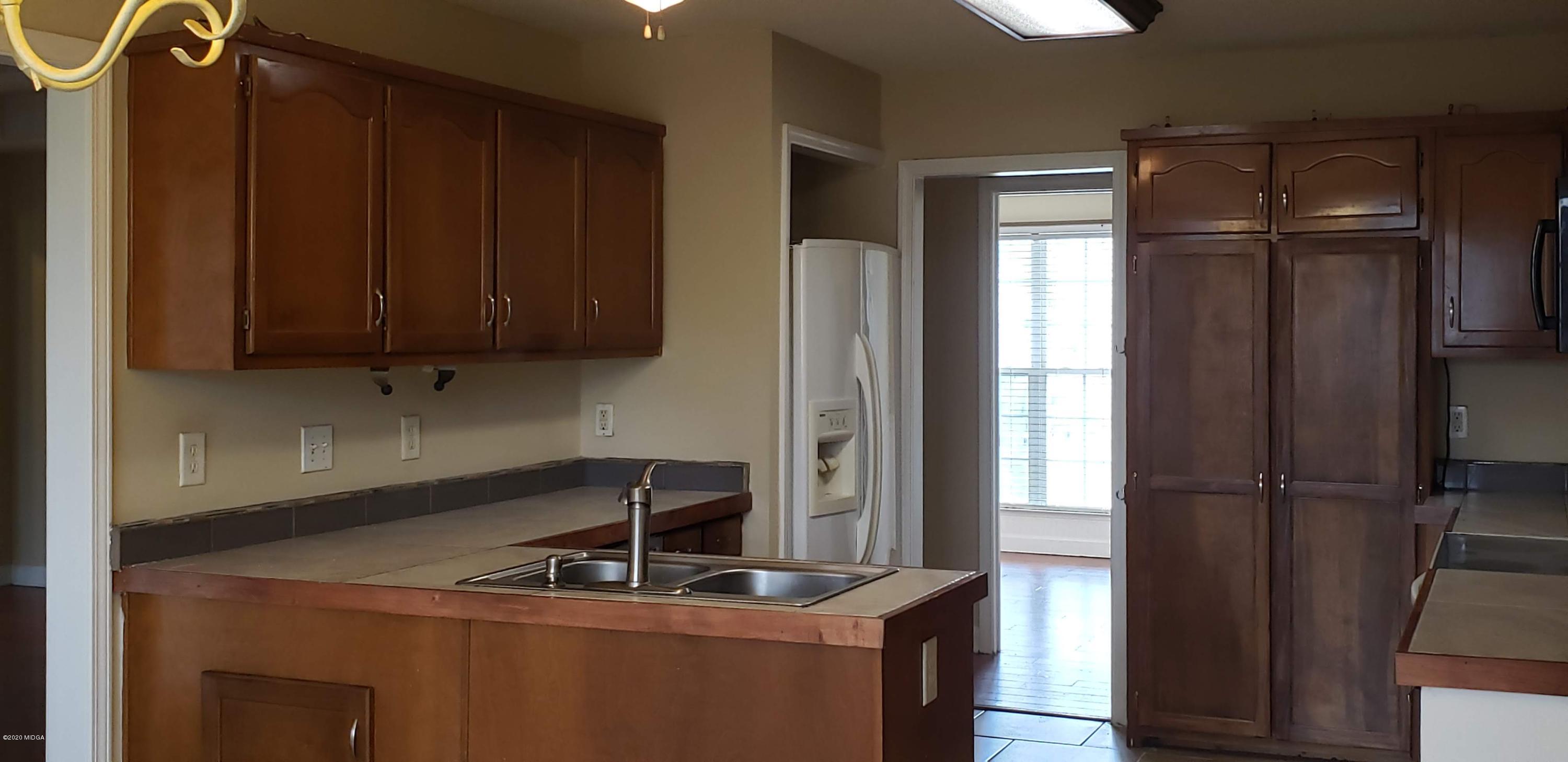 515 Amanda Way Macon, GA 31216 - Photo 13 of 33 a kitchen with a sink a refrigerator and window