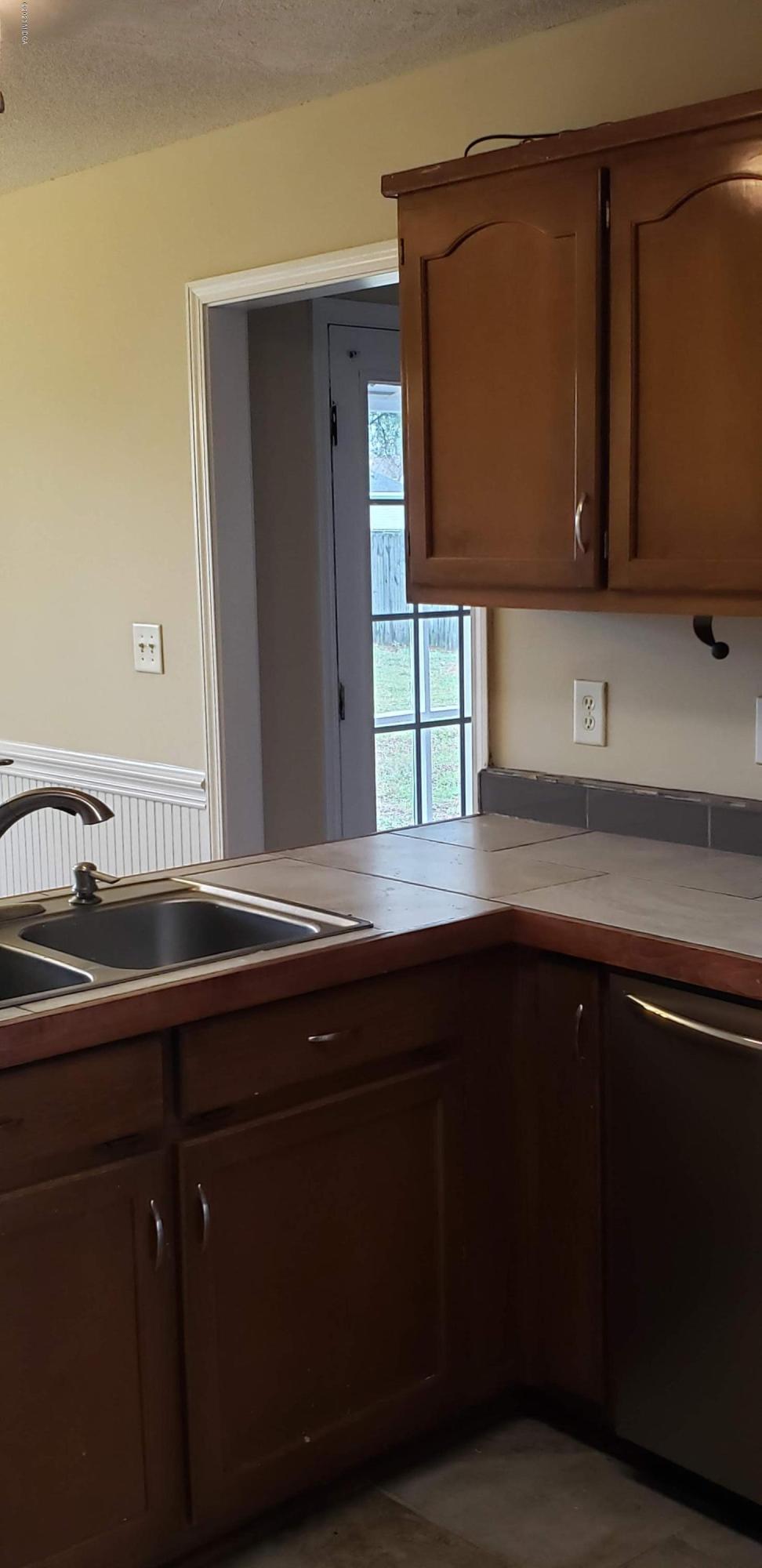 515 Amanda Way Macon, GA 31216 - Photo 15 of 33 a kitchen with a sink and cabinets