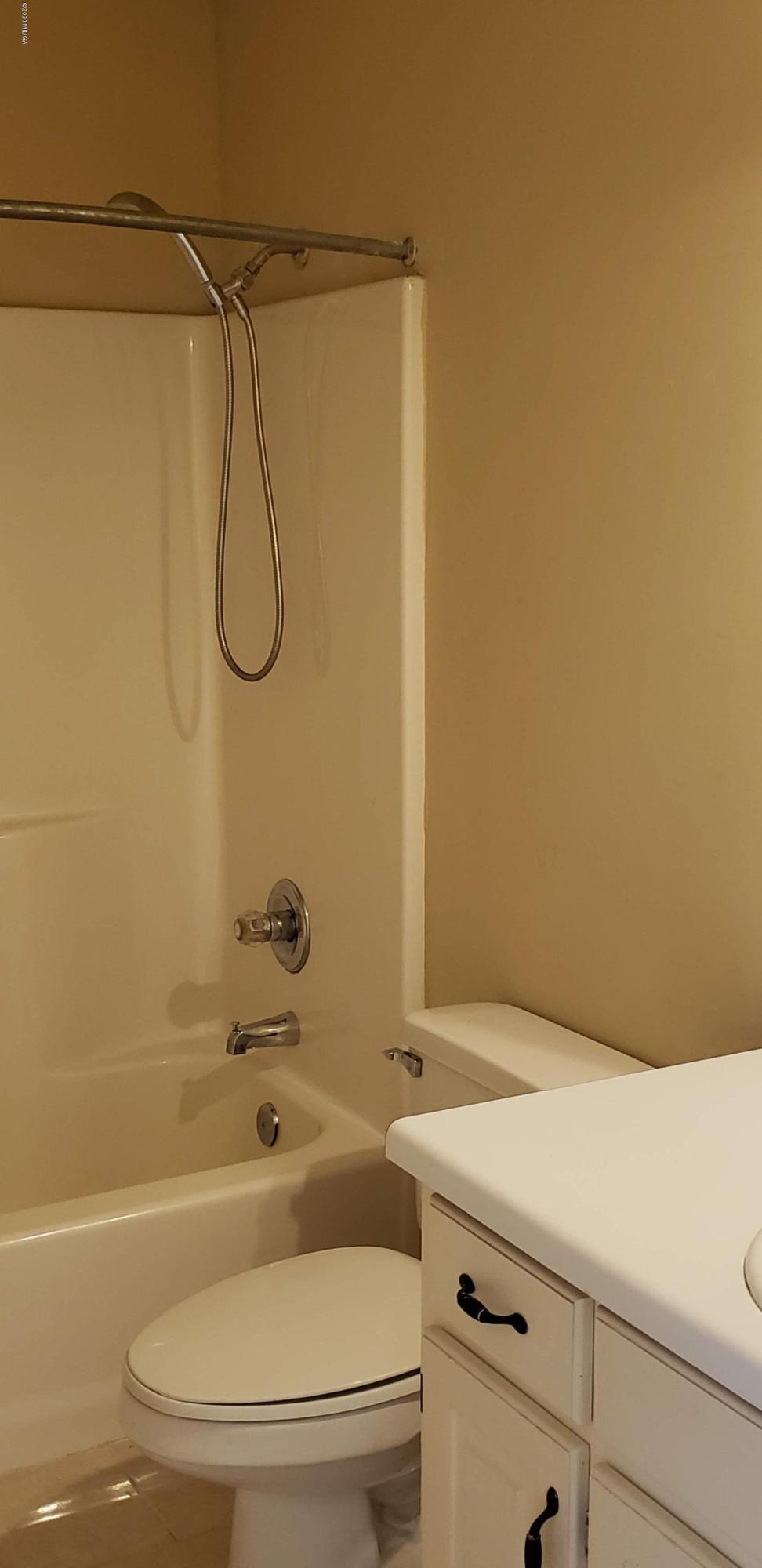 515 Amanda Way Macon, GA 31216 - Photo 20 of 33 a bathroom with a granite countertop bathtub shower sink vanity and toilet