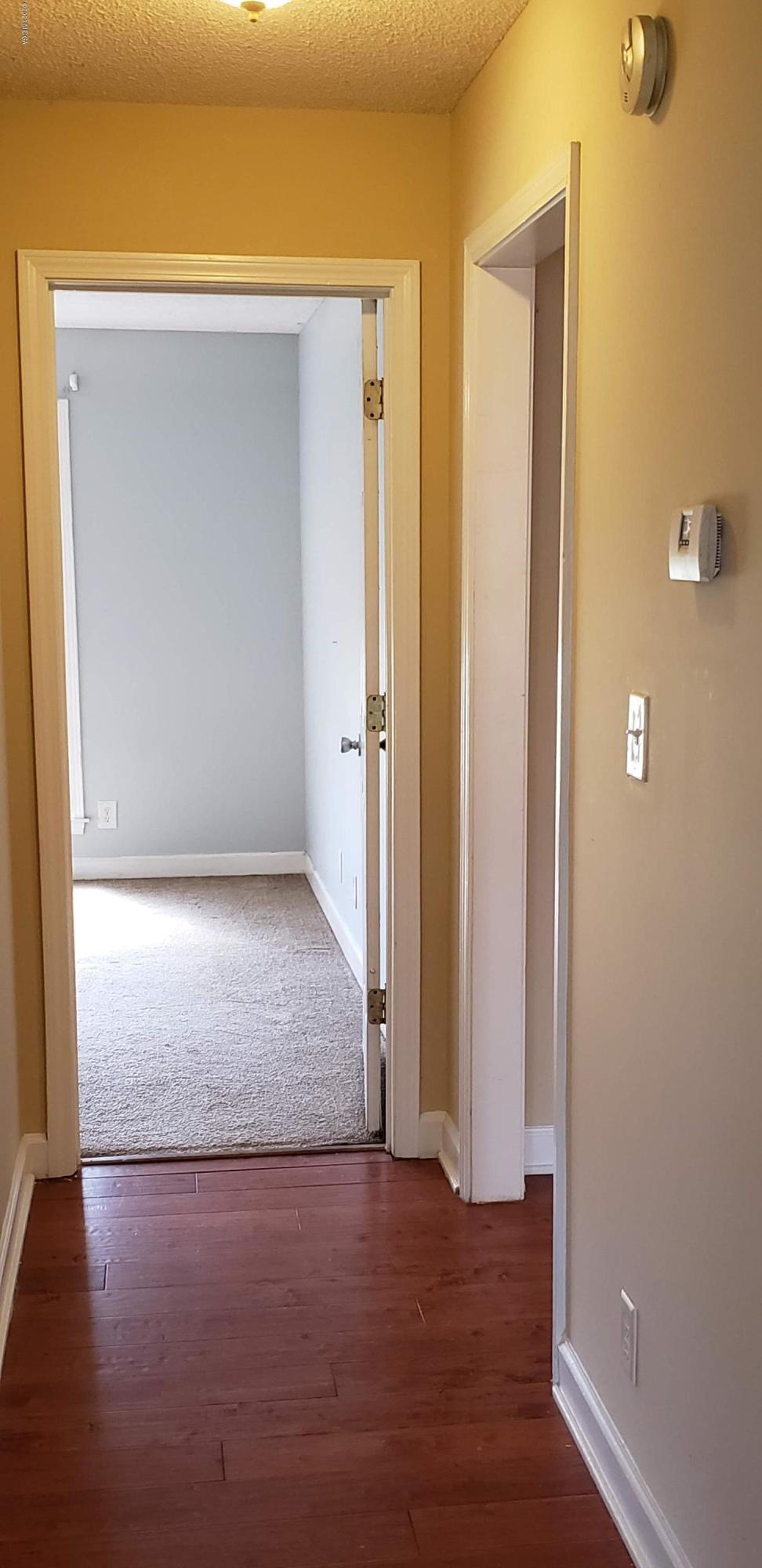 515 Amanda Way Macon, GA 31216 - Photo 23 of 33 an empty room with wooden floor and windows