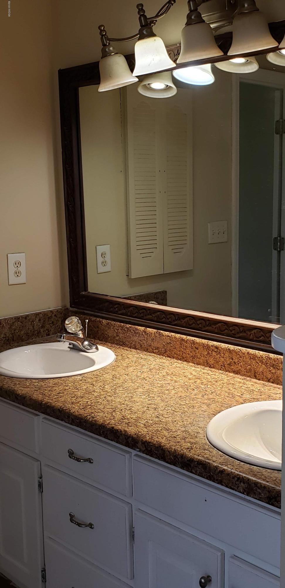515 Amanda Way Macon, GA 31216 - Photo 28 of 33 a bathroom with a granite countertop sink and a mirror