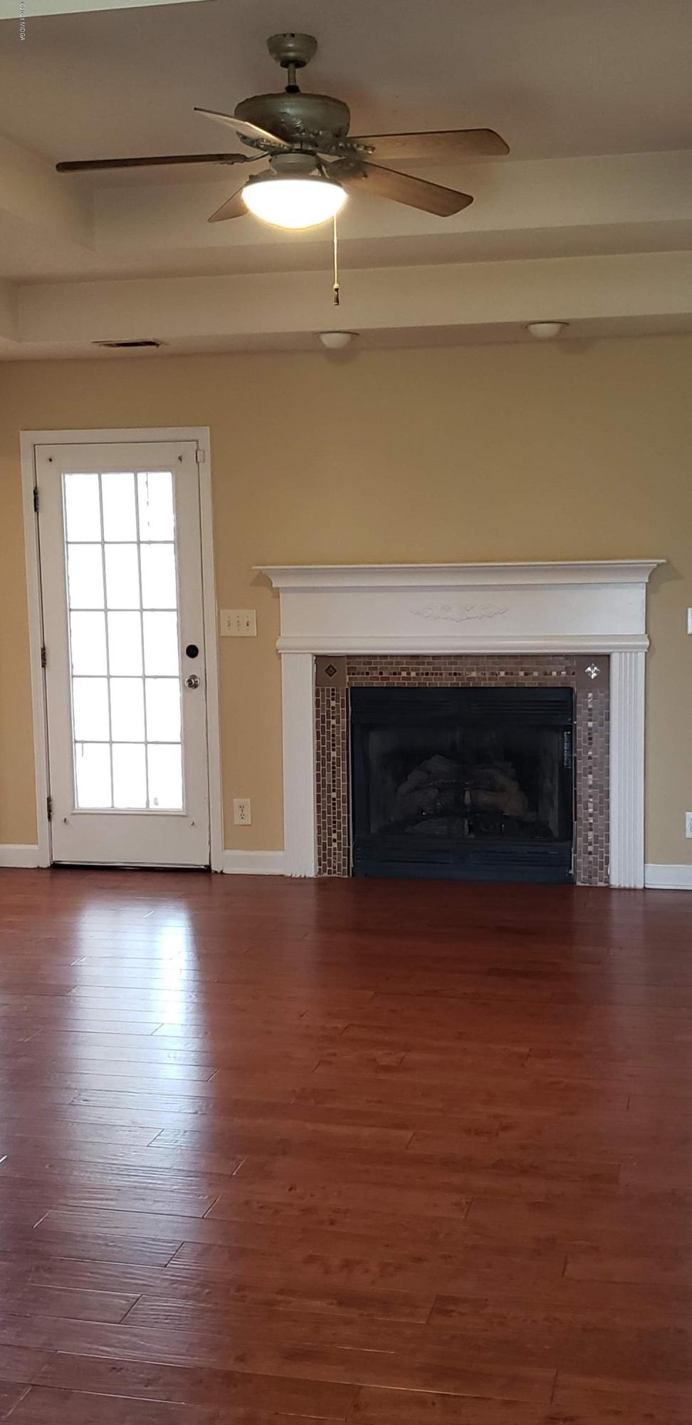 515 Amanda Way Macon, GA 31216 - Photo 8 of 33 a view of empty room with wooden floor and fireplace