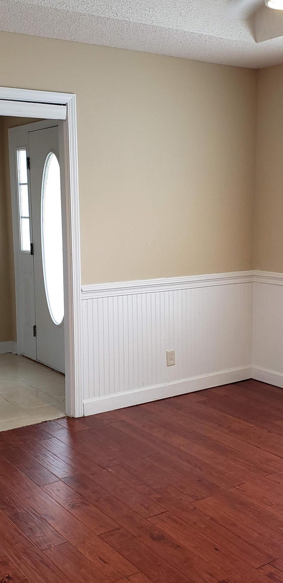 515 Amanda Way Macon, GA 31216 - Photo 9 of 33 a view of an empty room with wooden floor and a painting on the wall