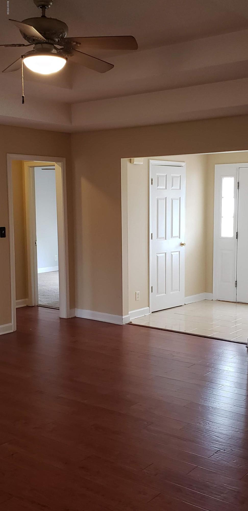 515 Amanda Way Macon, GA 31216 - Photo 10 of 33 a view of an empty room with wooden floor and a window