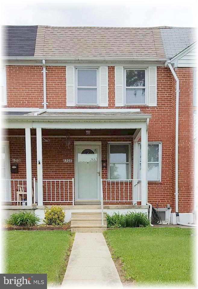 Charming brick front with a covered porch.