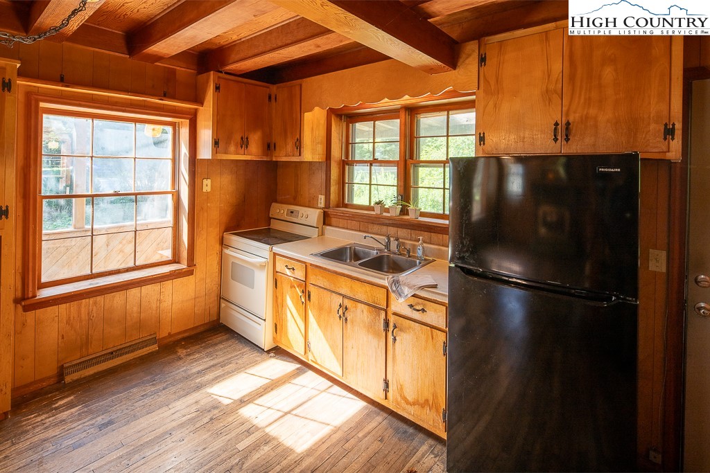 492 Payne Branch Road Boone, NC 28607 - Photo 15 of 49 a kitchen with a refrigerator a stove top oven a sink and a window