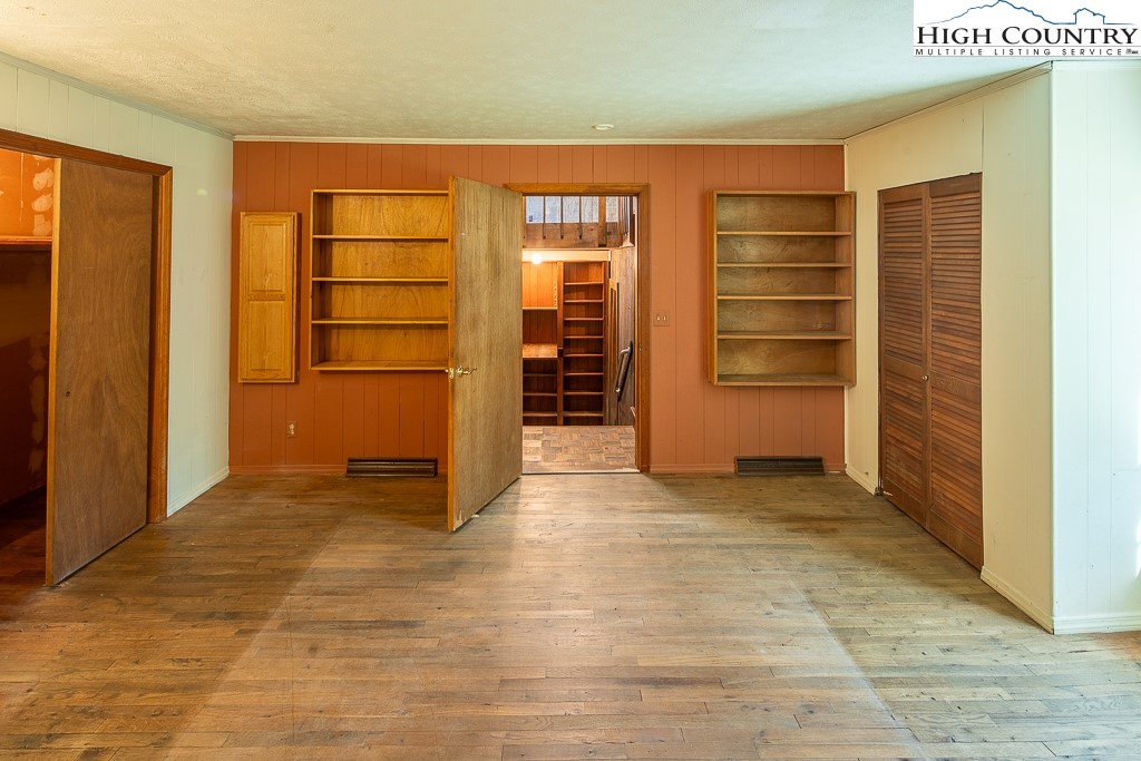 492 Payne Branch Road Boone, NC 28607 - Photo 22 of 49 an empty room with walk in closet and wooden floor