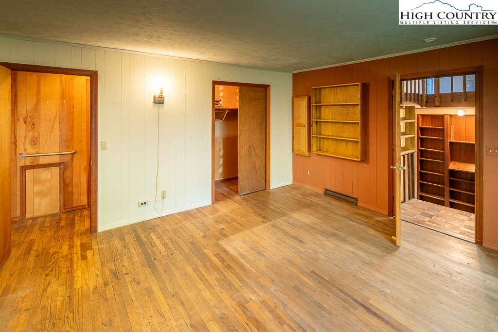 492 Payne Branch Road Boone, NC 28607 - Photo 23 of 49 a view of an empty room with wooden floor and a window