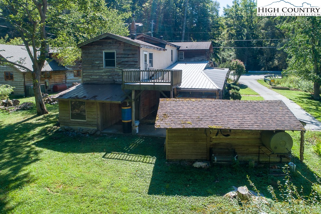 492 Payne Branch Road Boone, NC 28607 - Photo 47 of 49 a view of backyard with table and chairs potted plants and a large tree