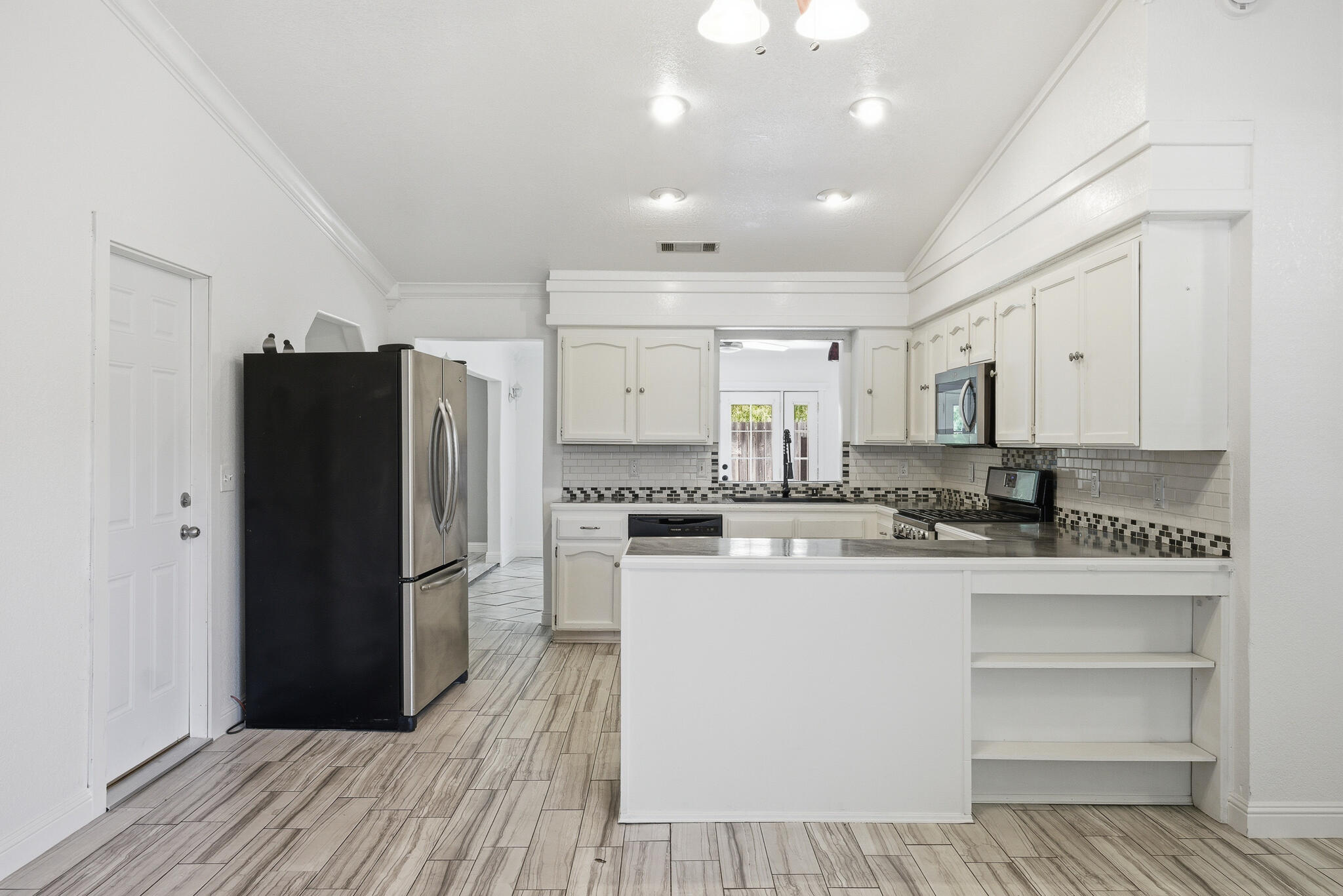 618 Birdsong Court Exeter, CA 93221 - Photo 8 of 62 a kitchen with a refrigerator and a stove top oven