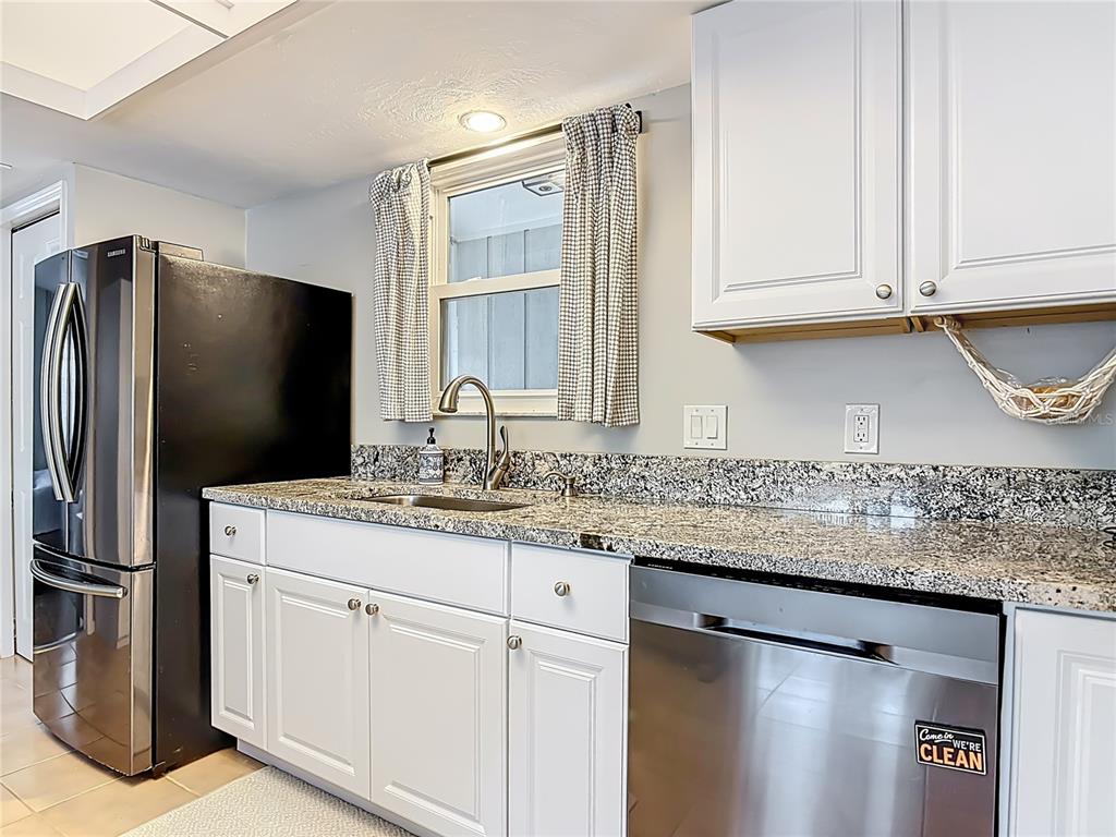 4748 Dixie Drive Ponce Inlet, FL 32127 - Photo 19 of 53 a kitchen with stainless steel appliances granite countertop a sink and a refrigerator