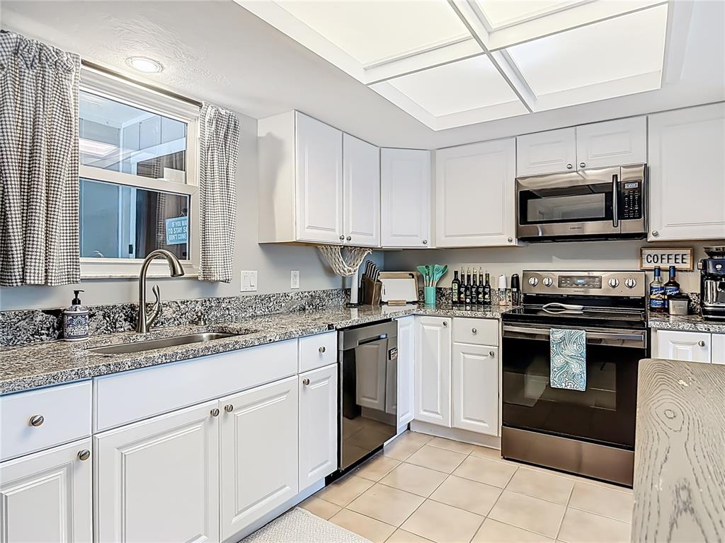 4748 Dixie Drive Ponce Inlet, FL 32127 - Photo 22 of 53 a kitchen with cabinets stainless steel appliances and a sink