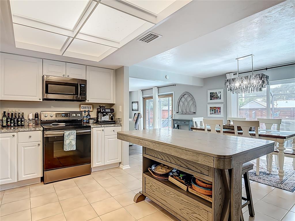 4748 Dixie Drive Ponce Inlet, FL 32127 - Photo 23 of 53 a kitchen with a stove a sink and a refrigerator