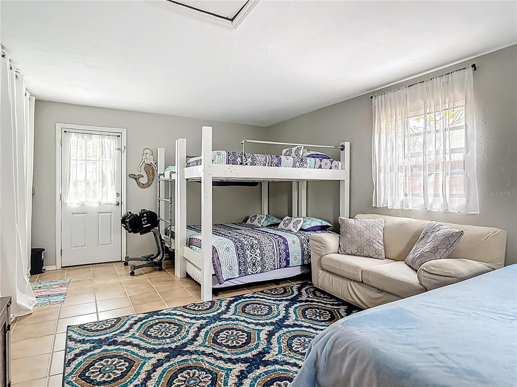 4748 Dixie Drive Ponce Inlet, FL 32127 - Photo 24 of 53 a bedroom with furniture and a window