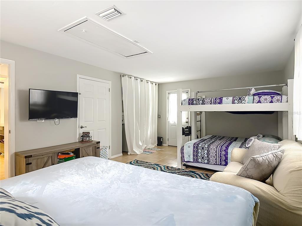 4748 Dixie Drive Ponce Inlet, FL 32127 - Photo 25 of 53 a bedroom with a bed and a flat screen tv
