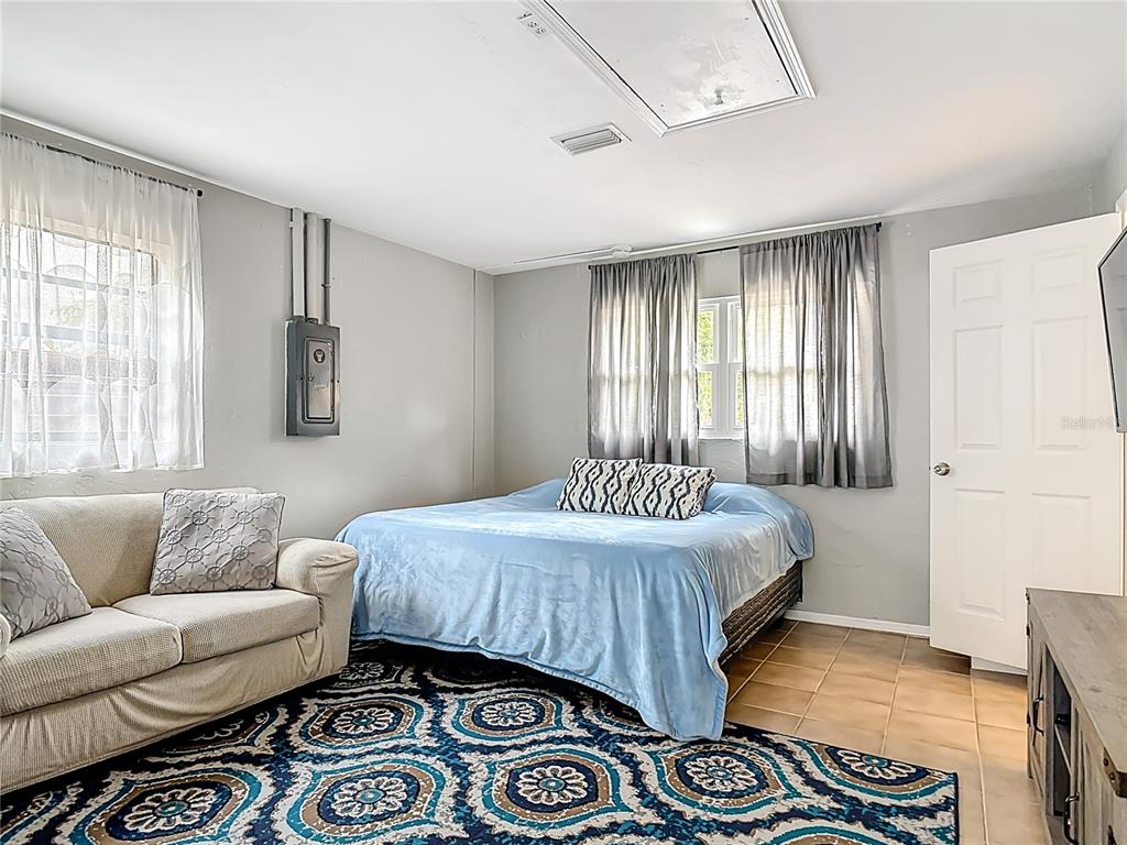 4748 Dixie Drive Ponce Inlet, FL 32127 - Photo 26 of 53 a bedroom with a bed and a couch