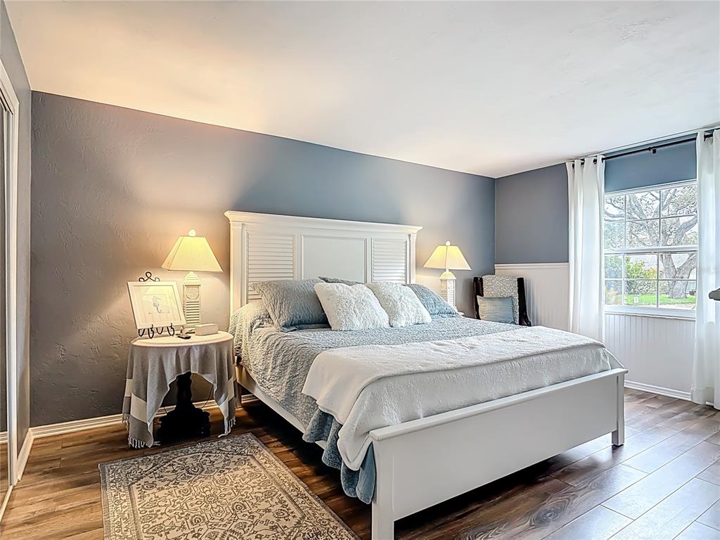 4748 Dixie Drive Ponce Inlet, FL 32127 - Photo 27 of 53 a bedroom with a bed and wooden floor