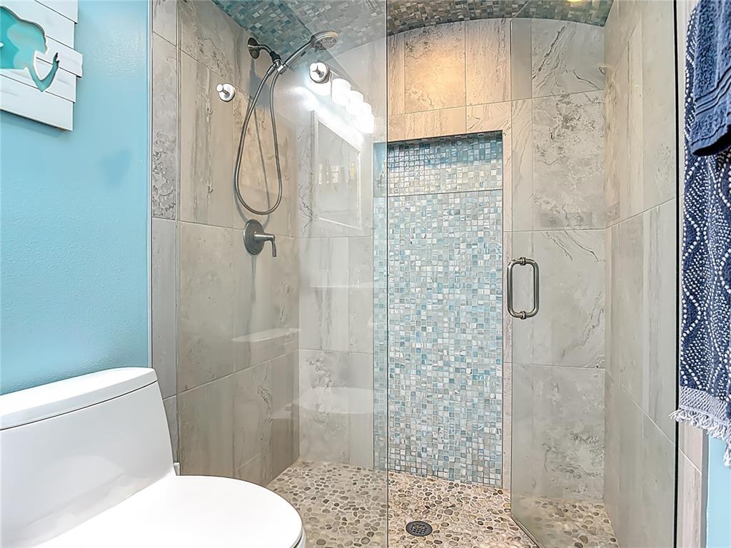 4748 Dixie Drive Ponce Inlet, FL 32127 - Photo 31 of 53 a bathroom with a toilet and a shower