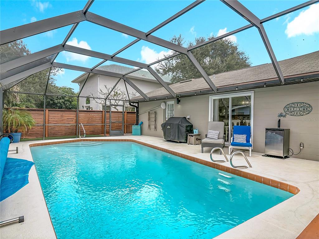 4748 Dixie Drive Ponce Inlet, FL 32127 - Photo 40 of 53 a view of a swimming pool with a patio and a yard