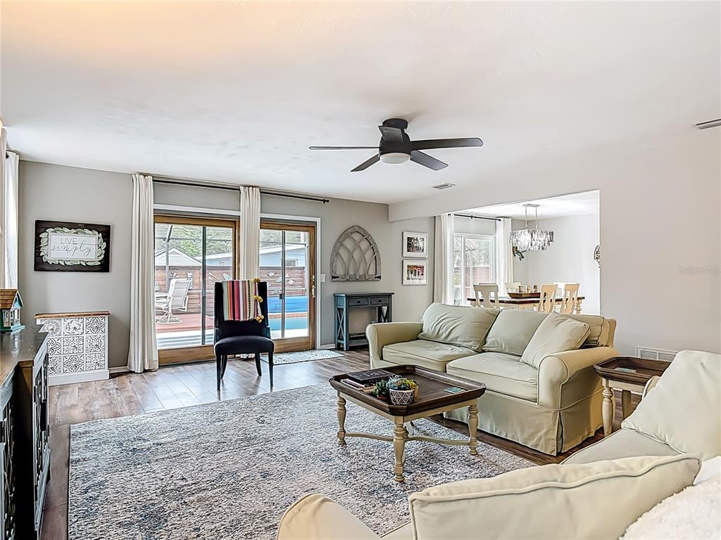 4748 Dixie Drive Ponce Inlet, FL 32127 - Photo 8 of 53 a living room with furniture a fireplace and a window