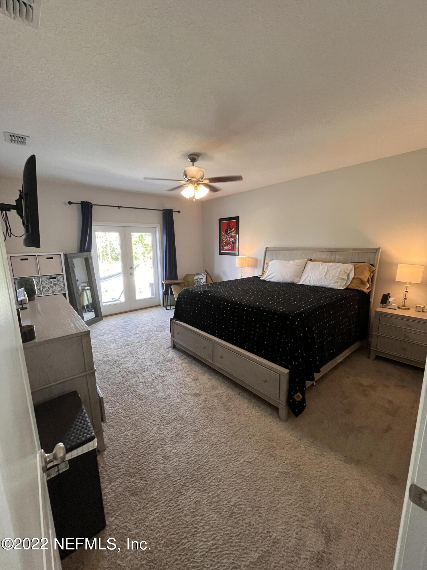 171 Ferndale Way St. Augustine, FL 32092 - Photo 12 of 35 a living room with a bed furniture and a flat screen tv