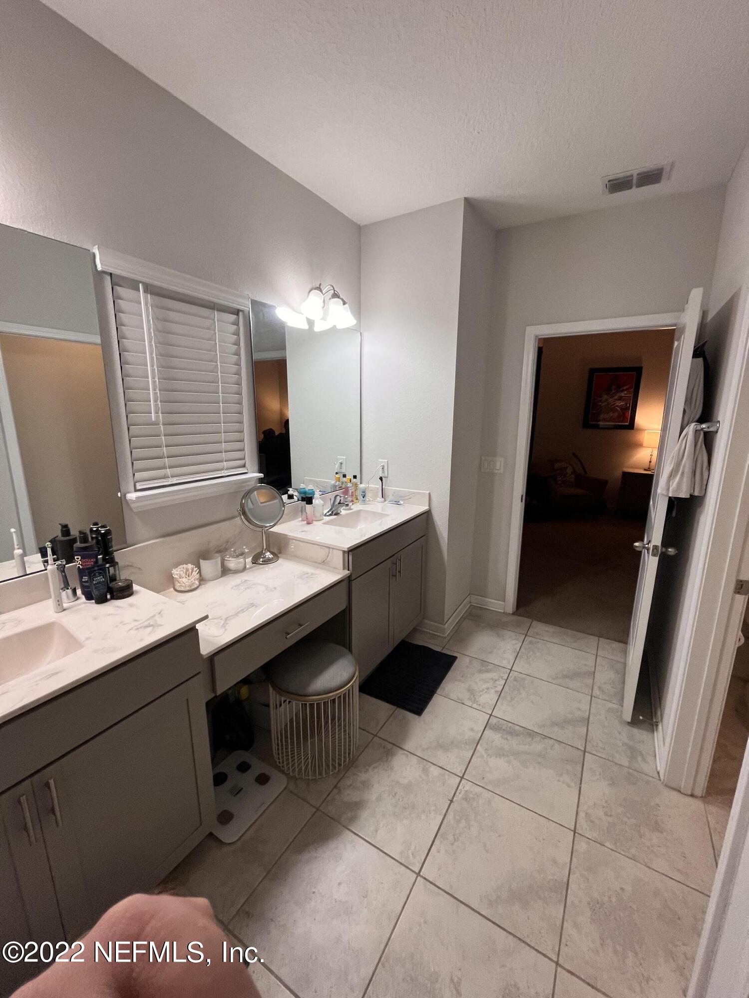 171 Ferndale Way St. Augustine, FL 32092 - Photo 15 of 35 a bathroom with a double vanity sink a and mirror