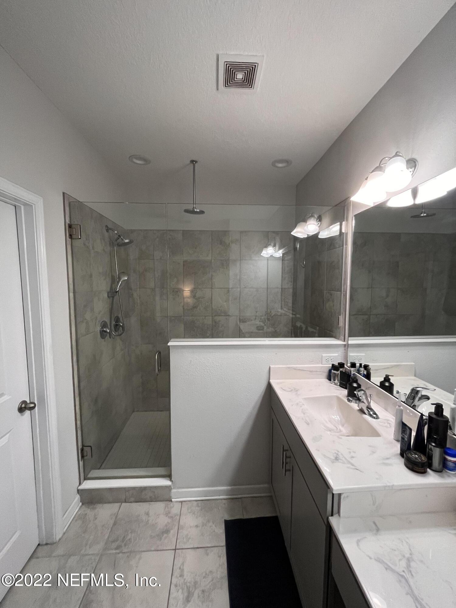 171 Ferndale Way St. Augustine, FL 32092 - Photo 16 of 35 a bathroom with a sink a shower and a mirror