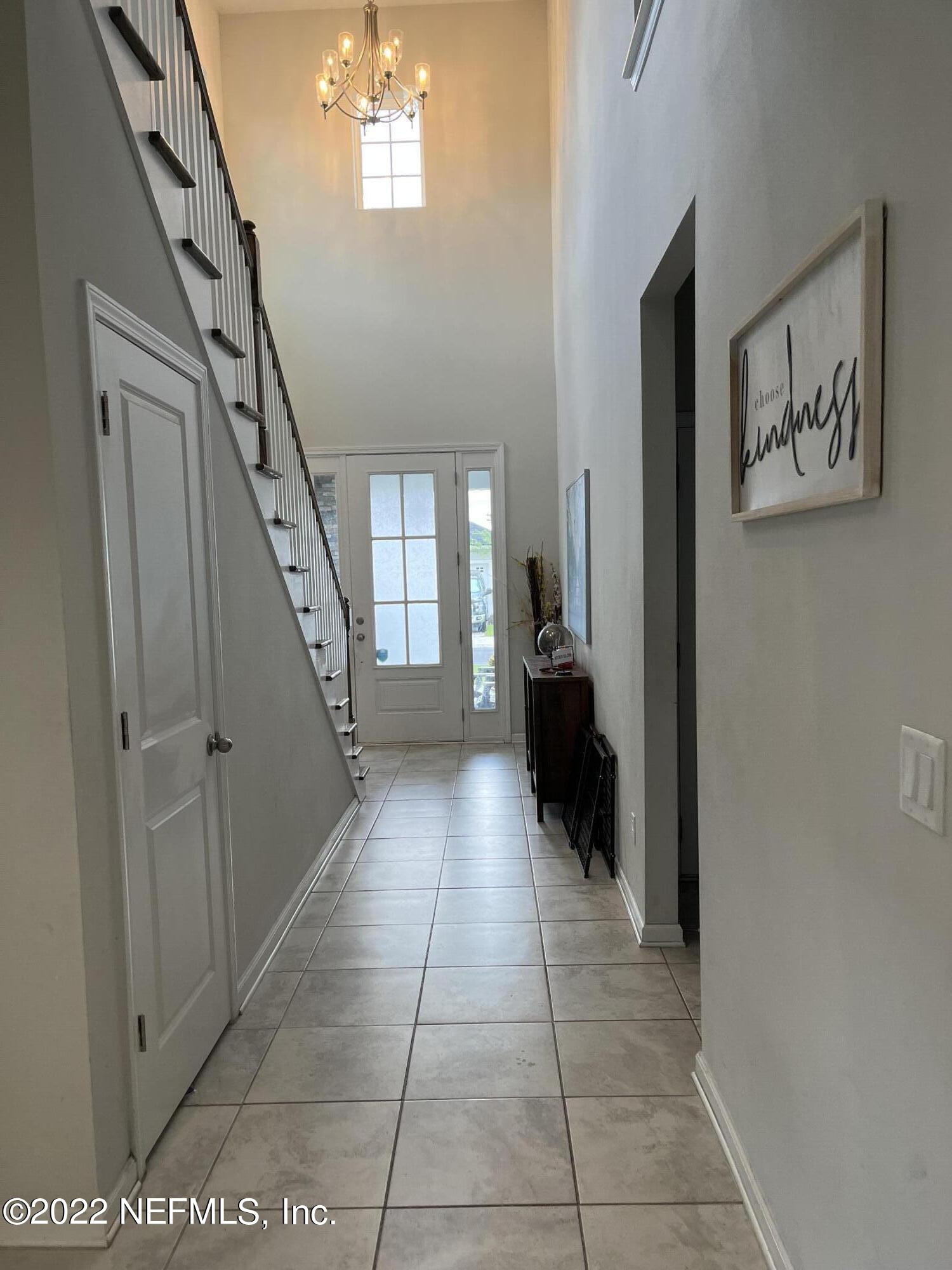 171 Ferndale Way St. Augustine, FL 32092 - Photo 2 of 35 a view of a hallway with wooden floor and staircase