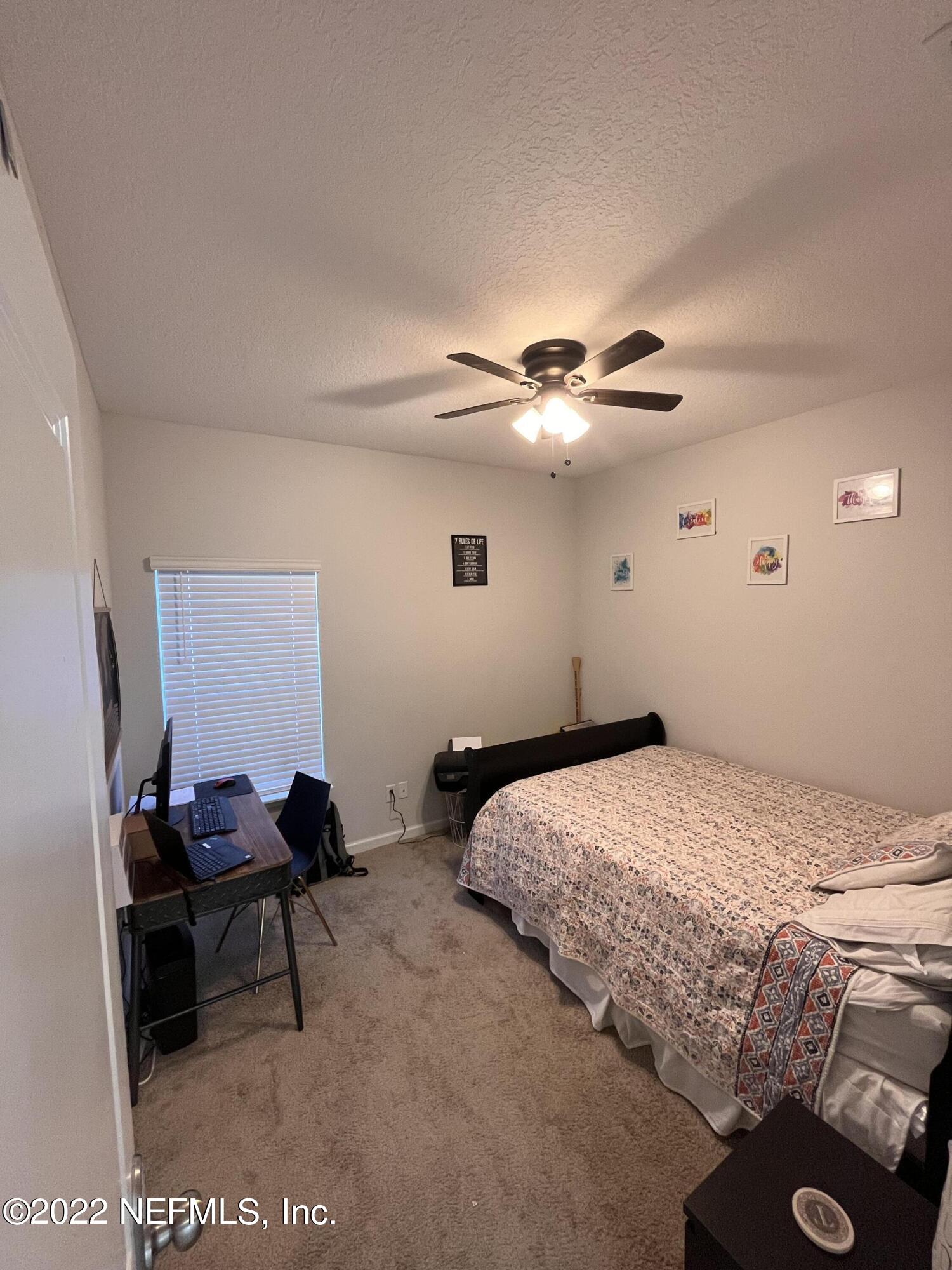 171 Ferndale Way St. Augustine, FL 32092 - Photo 25 of 35 a bedroom with a bed and a chandelier