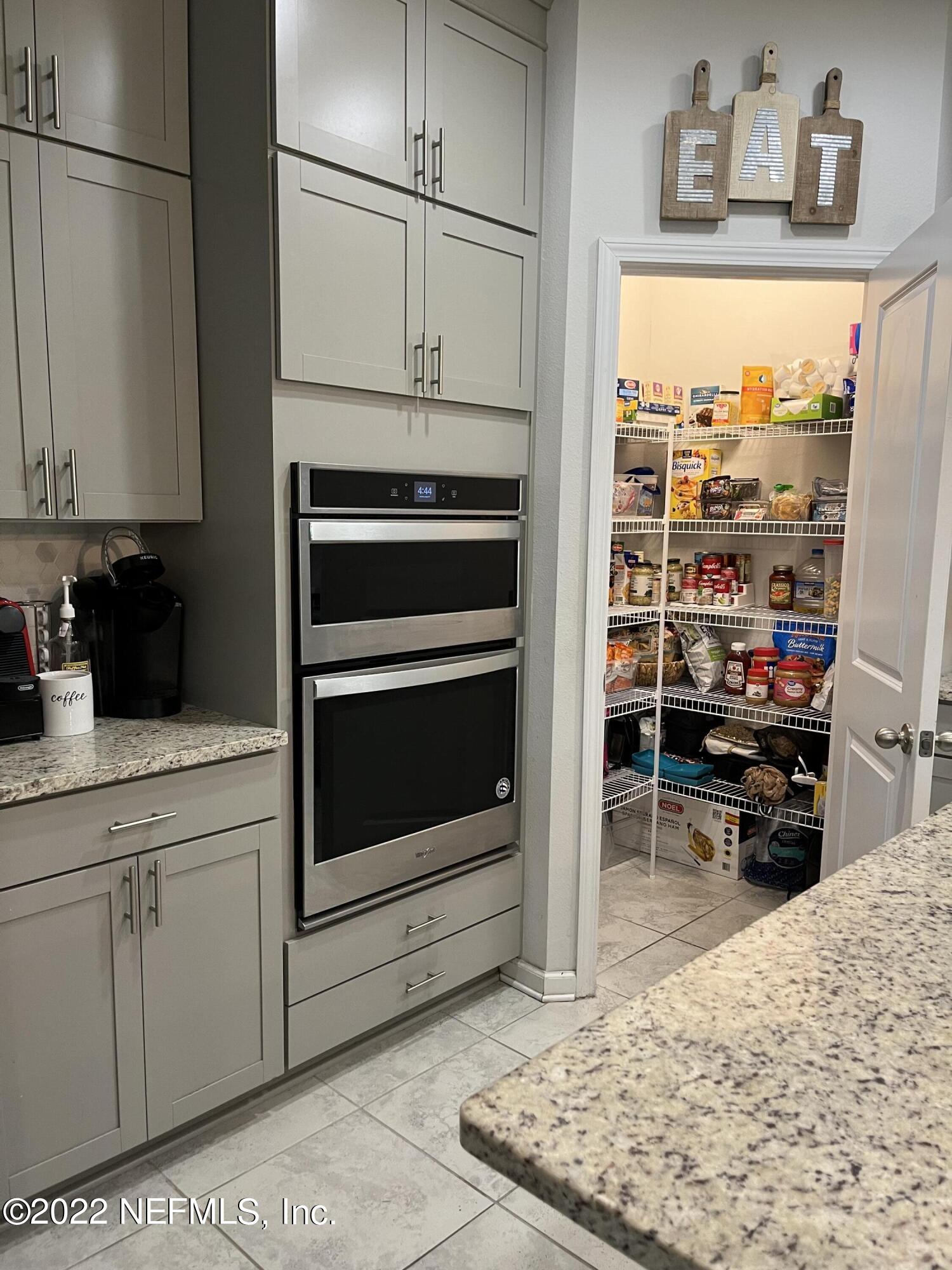 171 Ferndale Way St. Augustine, FL 32092 - Photo 5 of 35 a kitchen with stainless steel appliances granite countertop a stove and a refrigerator