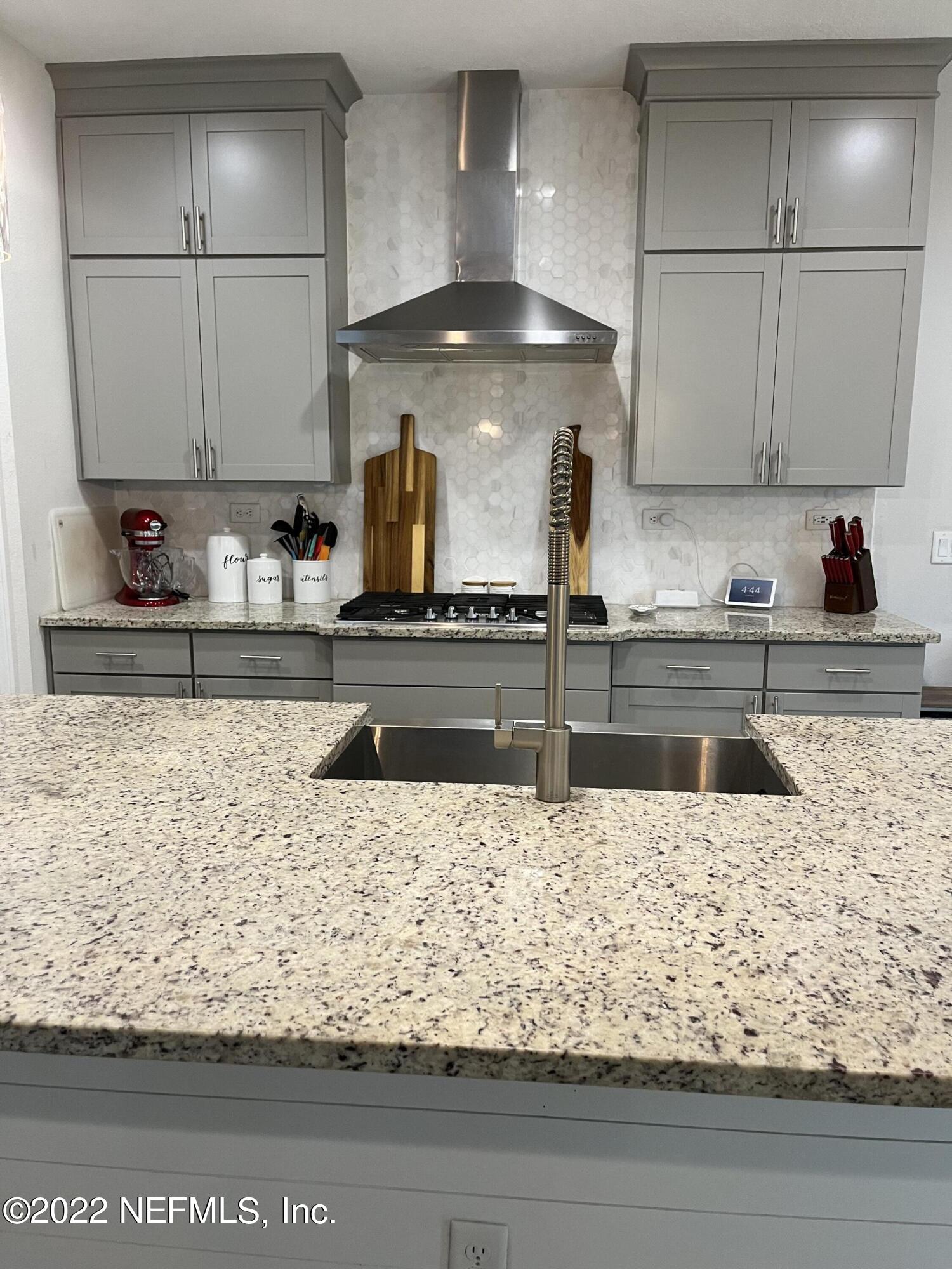 171 Ferndale Way St. Augustine, FL 32092 - Photo 6 of 35 a kitchen with stainless steel appliances granite countertop a sink and white cabinets