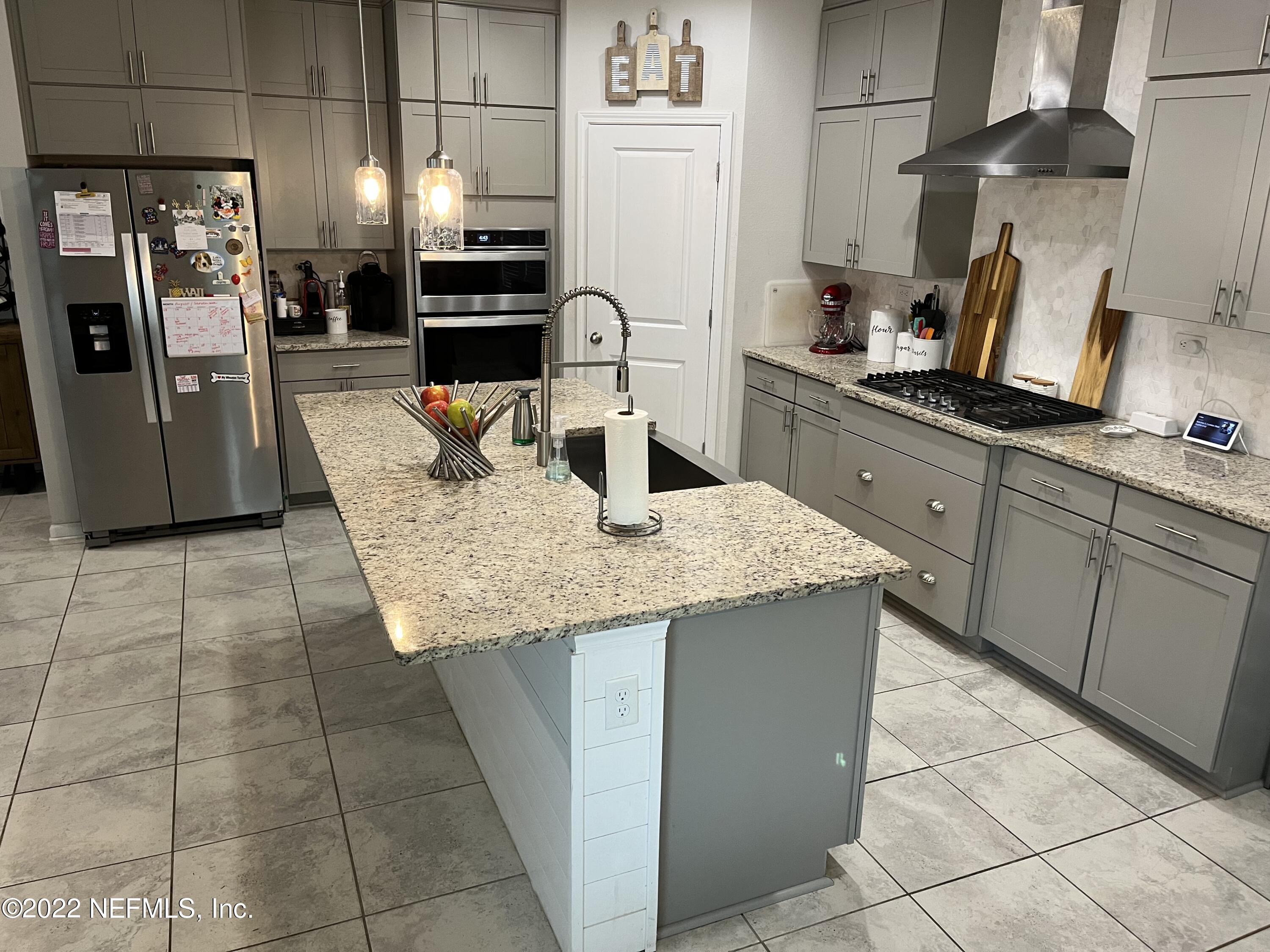 171 Ferndale Way St. Augustine, FL 32092 - Photo 7 of 35 a kitchen with granite countertop a refrigerator a stove and a sink