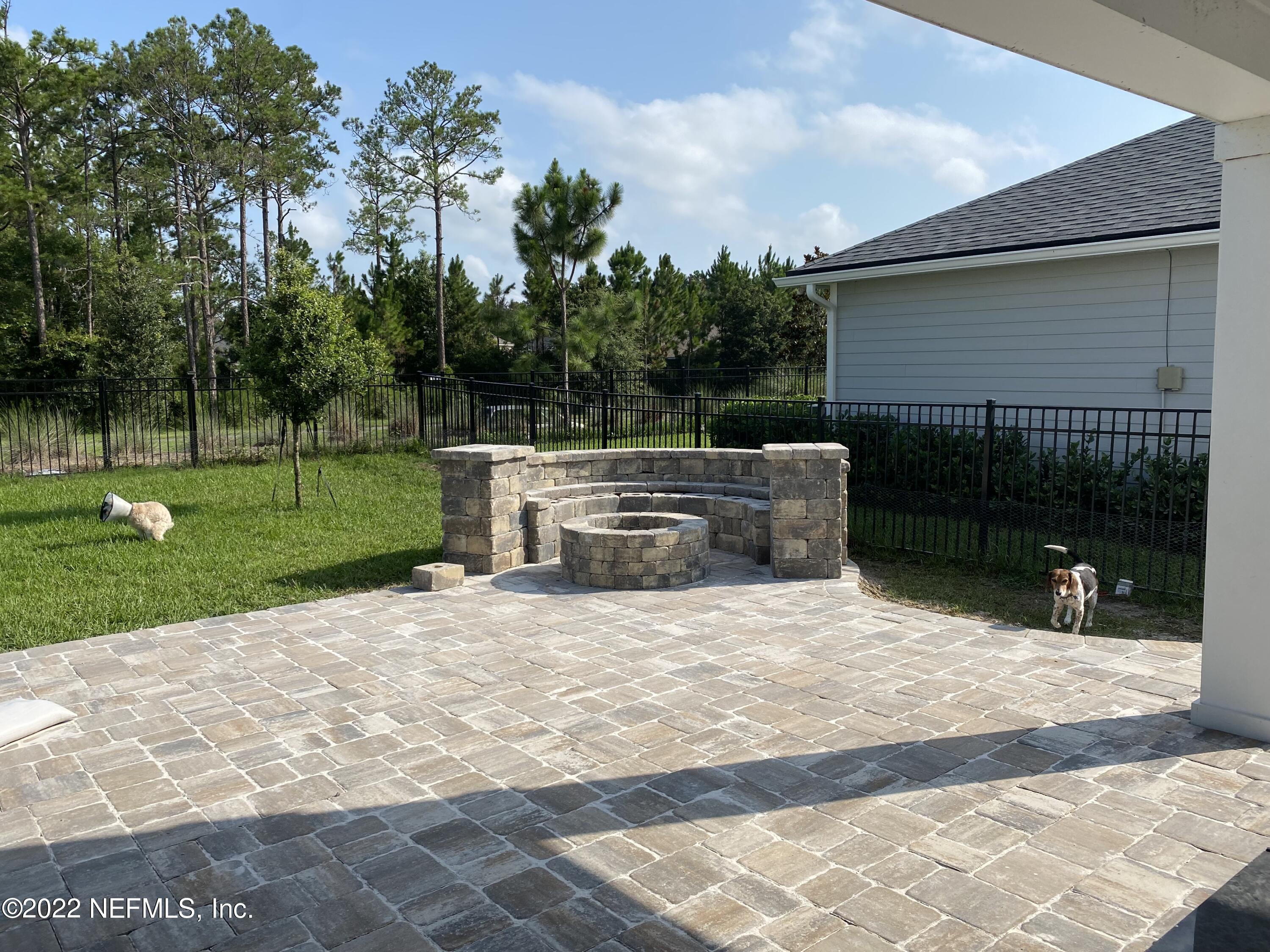 171 Ferndale Way St. Augustine, FL 32092 - Photo 9 of 35 a backyard of a house with lots of green space and garden