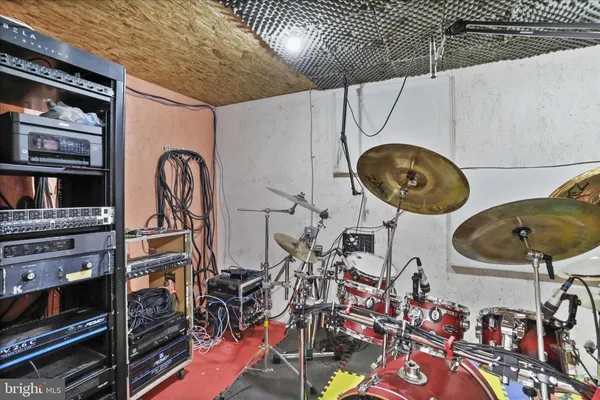 a view of a terrace with a bench and trees in the background