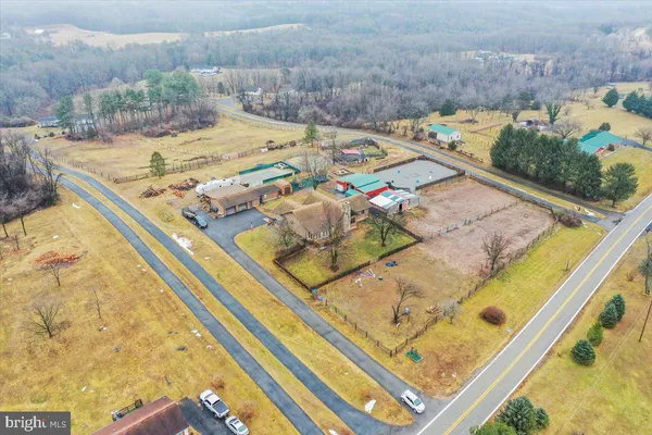a view of a house with a yard covered in snow