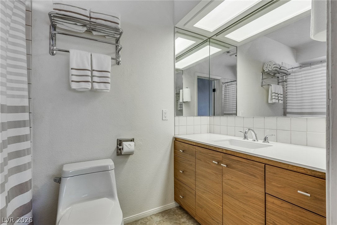 524 Swallow Cove Boulder City, NV 89005 - Photo 31 of 58 A sleek vanity with ample storage anchors this well-lit bathing space.