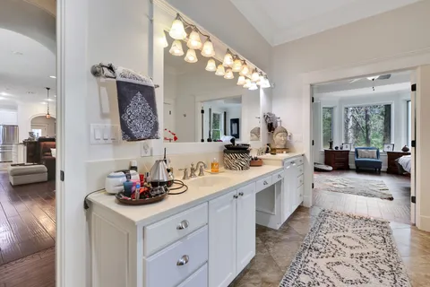 a spacious bathroom with a double vanity sink and a mirror