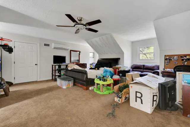 a view of a livingroom with furniture and a window