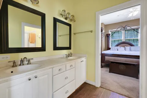 a en suite bathroom with a double vanity sink and a mirror