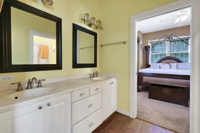 a en suite bathroom with a double vanity sink and a mirror