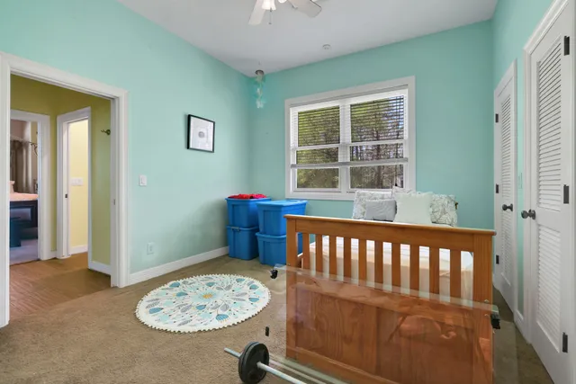 a view of a bedroom with furniture and window