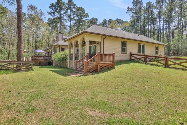 a view of a house with backyard and sitting area