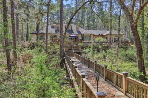 a balcony with wooden fence and trees