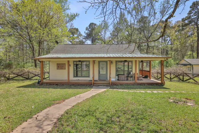 a front view of a house with a yard and porch