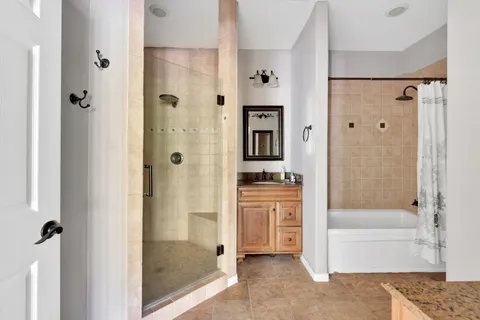 a bathroom with a shower and a bath tub