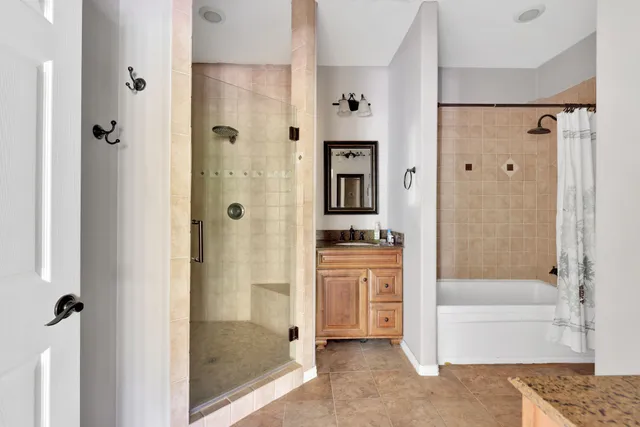 a bathroom with a shower and a bath tub